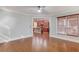 Hardwood floor living room with view into kitchen and access to the outdoors at 588 Myrtle Trace Ln, Suwanee, GA 30024