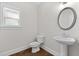 Simple bathroom with pedestal sink, toilet and hardwood floors at 969 Rittenhouse Way, Atlanta, GA 30316