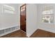 Entryway with built-in bench, hardwood floors, and a wood door at 969 Rittenhouse Way, Atlanta, GA 30316