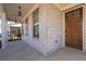 Front porch with brick columns and a wooden door at 969 Rittenhouse Way, Atlanta, GA 30316