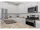 Modern kitchen with white cabinets, granite countertops, and stainless steel appliances at 969 Rittenhouse Way, Atlanta, GA 30316