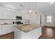 Modern kitchen with white cabinets, granite island, and stainless steel appliances at 969 Rittenhouse Way, Atlanta, GA 30316