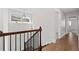 Upstairs hallway with hardwood floors and a view into another room at 969 Rittenhouse Way, Atlanta, GA 30316