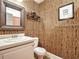 Small bathroom with wood-like wallpaper and updated vanity at 1858 Windemere Ne Dr, Atlanta, GA 30324