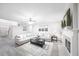 Light and airy living room featuring an L-shaped sofa and a fireplace at 8215 Aulden Pl, Cumming, GA 30041