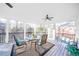 Relaxing screened porch with seating area and ceiling fan at 8215 Aulden Pl, Cumming, GA 30041