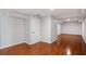 Unfinished basement area featuring hardwood floors, neutral paint, and a utility door at 1362 Meadow Creek Nw Way, Acworth, GA 30102