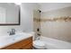 Clean bathroom with tub/shower combo, wood vanity, and neutral tile at 1362 Meadow Creek Nw Way, Acworth, GA 30102