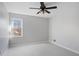 Neutral bedroom with fan, window, and carpeted floors at 1362 Meadow Creek Nw Way, Acworth, GA 30102