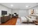 Well-lit bedroom with hardwood floors, a desk, and a decorative rug at 1362 Meadow Creek Nw Way, Acworth, GA 30102