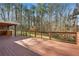 Wood deck with outdoor kitchen and built-in grill overlooking a private backyard at 1362 Meadow Creek Nw Way, Acworth, GA 30102