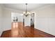 Dining room with hardwood floors, chandelier, chair rail, and open view to living areas at 1362 Meadow Creek Nw Way, Acworth, GA 30102