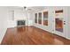 Gathering room with hardwood floors, fireplace, built-in shelving, and access to deck at 1362 Meadow Creek Nw Way, Acworth, GA 30102