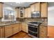 Modern kitchen with stainless steel appliances and light wood cabinets at 1362 Meadow Creek Nw Way, Acworth, GA 30102