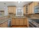 Kitchen with granite countertops, stainless steel appliances, and wood cabinets at 1362 Meadow Creek Nw Way, Acworth, GA 30102