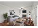 Cozy living room with a fireplace, built-in shelving, and ample seating at 1362 Meadow Creek Nw Way, Acworth, GA 30102