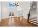 Bright and spacious living room with an adjacent staircase featuring hardwood floors and tall ceilings at 1362 Meadow Creek Nw Way, Acworth, GA 30102