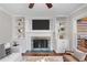 Cozy living room featuring a fireplace with built-in bookshelves and plenty of natural light at 1362 Meadow Creek Nw Way, Acworth, GA 30102