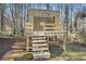 Detailed view of a wooden playset with stairs and a roof at 1362 Meadow Creek Nw Way, Acworth, GA 30102