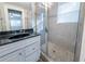 Clean bathroom, white vanity, granite countertop, and shower at 1453 Graham Sw St, Atlanta, GA 30310