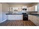 Renovated kitchen featuring white cabinets and granite countertops at 1453 Graham Sw St, Atlanta, GA 30310