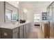 Spa-like bathroom with double vanity and a view into the bedroom at 1603 Caldwell Bend Ln, Dacula, GA 30019