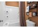 Bathroom featuring a shower-tub, storage shelves, and toilet with decorative towels at 1603 Caldwell Bend Ln, Dacula, GA 30019