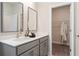 Bright bathroom featuring double vanity, walk-in closet with robe at 1603 Caldwell Bend Ln, Dacula, GA 30019