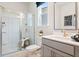 Bathroom featuring a glass-enclosed shower, window, and vanity at 1603 Caldwell Bend Ln, Dacula, GA 30019