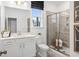 Clean bathroom with a glass shower, modern vanity, and grey tile flooring at 1603 Caldwell Bend Ln, Dacula, GA 30019