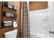 Bathroom featuring a tub and shower combination, towel racks, and soft lighting at 1603 Caldwell Bend Ln, Dacula, GA 30019