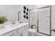 Modern bathroom featuring a glass shower, quartz countertop, and white cabinets at 1603 Caldwell Bend Ln, Dacula, GA 30019