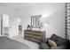 Cozy bedroom featuring a dresser, mirror, chair, and soft natural light at 1603 Caldwell Bend Ln, Dacula, GA 30019