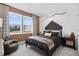 Modern bedroom with a unique branch light fixture, large windows, and comfortable seating at 1603 Caldwell Bend Ln, Dacula, GA 30019