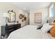Bright bedroom features a bed, dresser, bedside table and decorative wall art at 1603 Caldwell Bend Ln, Dacula, GA 30019