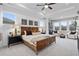 Bedroom with large windows, a tray ceiling, and elegant seating area at 1603 Caldwell Bend Ln, Dacula, GA 30019