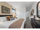 Bedroom with hardwood floors, a large bed, coordinated furniture, and a view of closet at 1603 Caldwell Bend Ln, Dacula, GA 30019