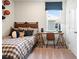 Sunlit bedroom with window view and a study area at 1603 Caldwell Bend Ln, Dacula, GA 30019