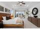 Spacious bedroom with a tray ceiling, natural light, and stylish decor at 1603 Caldwell Bend Ln, Dacula, GA 30019