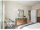 Bright bedroom featuring a dresser with decor, next to an open door to the bathroom at 1603 Caldwell Bend Ln, Dacula, GA 30019