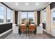 Modern dining room with stylish chairs, decorative rug, and large windows for natural light at 1603 Caldwell Bend Ln, Dacula, GA 30019