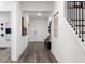Bright entryway featuring wood floors, staircase, and decorations on the walls at 1603 Caldwell Bend Ln, Dacula, GA 30019