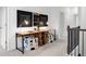 Upstairs hallway featuring a work space with side-by-side desks and comfortable seating at 1603 Caldwell Bend Ln, Dacula, GA 30019