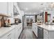 Modern kitchen boasts white cabinetry, stainless appliances, and a sleek design with gray tone flooring at 1603 Caldwell Bend Ln, Dacula, GA 30019