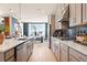 Modern kitchen with stainless steel appliances, plenty of counter space, and open flow to the dining and living areas at 1603 Caldwell Bend Ln, Dacula, GA 30019