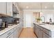 Modern kitchen with light gray cabinets, island, and stainless steel appliances at 1603 Caldwell Bend Ln, Dacula, GA 30019