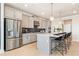 Modern kitchen with light gray cabinets, island, and stainless steel appliances at 1603 Caldwell Bend Ln, Dacula, GA 30019