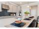 Beautiful kitchen with stainless steel appliances, navy backsplash, and seating at the island at 1603 Caldwell Bend Ln, Dacula, GA 30019