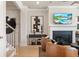 Cozy living room with a fireplace, modern decor, and staircase access, creating an inviting and stylish ambiance at 1603 Caldwell Bend Ln, Dacula, GA 30019