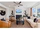 Inviting living room with modern decor, a cozy fireplace, hardwood floors, and ample natural light, perfect for relaxation at 1603 Caldwell Bend Ln, Dacula, GA 30019